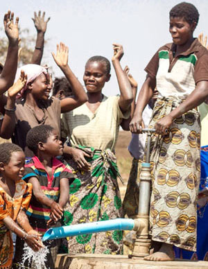 Women and children at a new well.