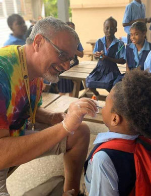 Camp Carew's Director Dan Kingery putting floride on teeth in Belize.