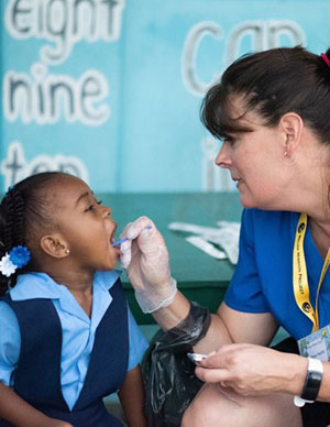 Dental technician examining a little girl.